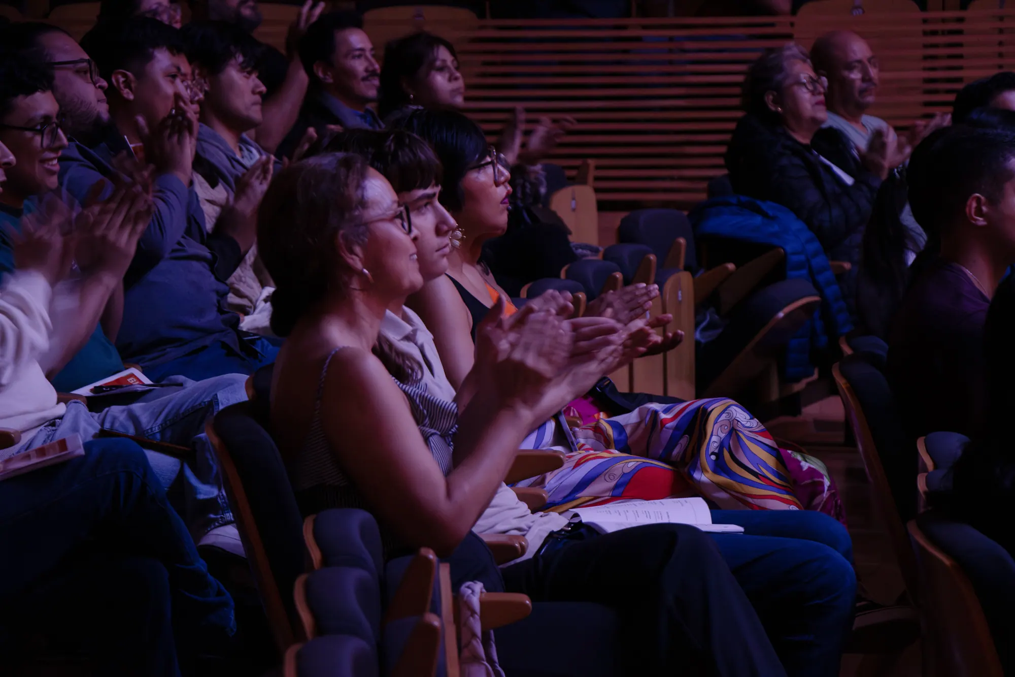 Audience applauding in a concert hall during an ALMA Boston performance