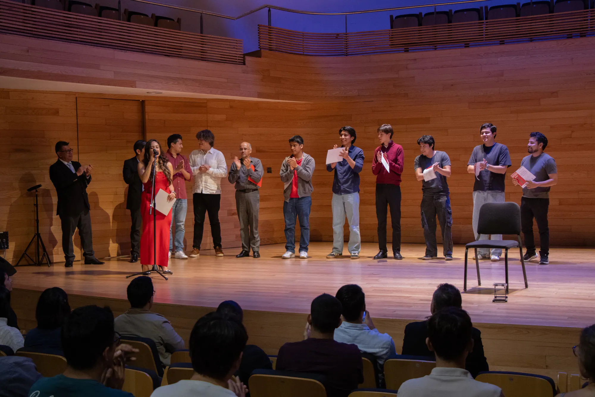 Young guitarists receiving their awards on stage at a concert hall